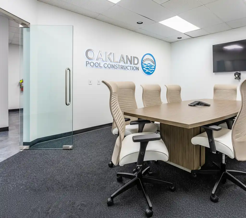 Oakland Pool Construction office interior with company logo and branding on wall